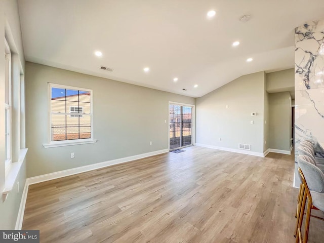 empty room with recessed lighting, visible vents, light wood-style flooring, and baseboards