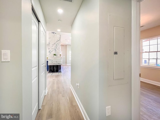 hallway featuring recessed lighting, baseboards, visible vents, and light wood finished floors