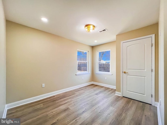 unfurnished bedroom featuring recessed lighting, light wood-type flooring, visible vents, and baseboards