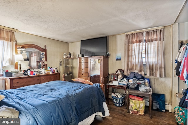 bedroom featuring a textured ceiling and dark wood-style flooring