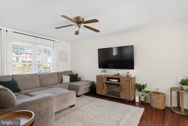 living room featuring a ceiling fan and dark wood finished floors