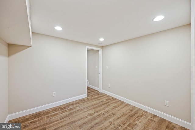 finished basement with recessed lighting, light wood-style flooring, and baseboards