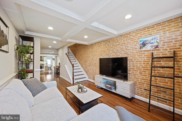 living room featuring beam ceiling, dark wood-style flooring, stairway, brick wall, and coffered ceiling