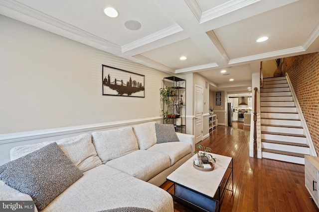 living area featuring dark wood-style flooring, coffered ceiling, ornamental molding, stairway, and beamed ceiling