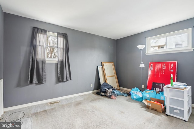 interior space featuring carpet floors, visible vents, and baseboards