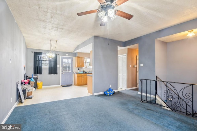 interior space featuring light carpet, an inviting chandelier, and baseboards