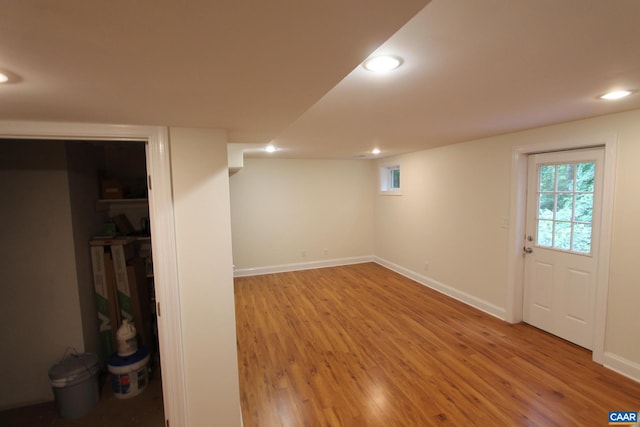 below grade area featuring light wood-style floors, baseboards, and recessed lighting