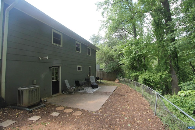 back of house with a patio, a fenced backyard, and cooling unit