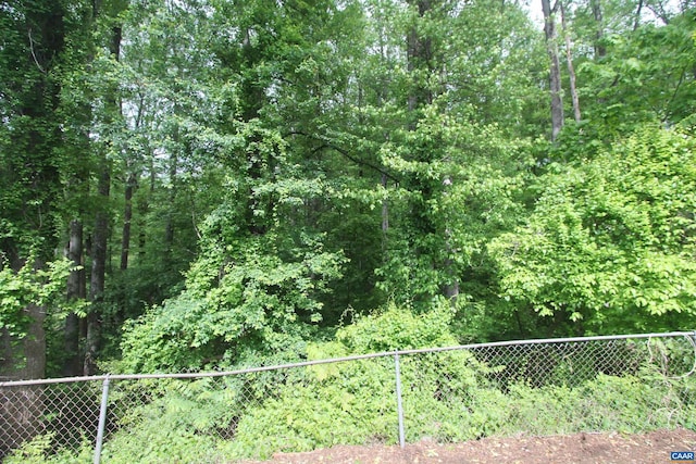 exterior space featuring fence and a view of trees