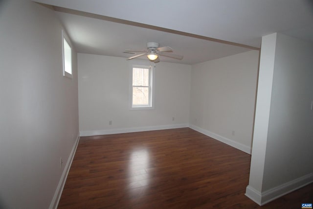 spare room featuring ceiling fan, baseboards, and wood finished floors