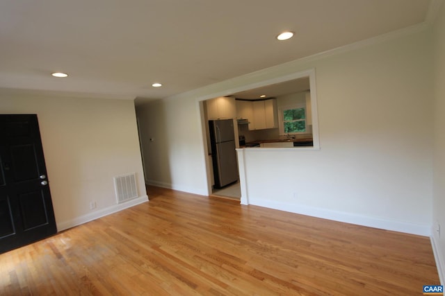 unfurnished living room with baseboards, recessed lighting, visible vents, and light wood-style floors