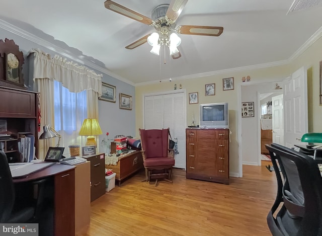 office area with light wood finished floors, a ceiling fan, visible vents, and crown molding