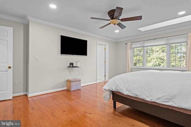 bedroom with hardwood / wood-style flooring, baseboards, ornamental molding, and recessed lighting