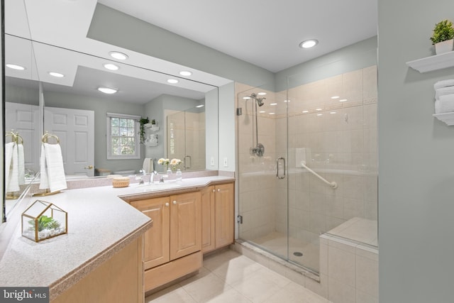 bathroom with recessed lighting, a stall shower, tile patterned floors, and vanity