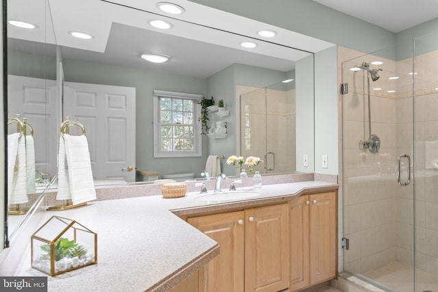 bathroom featuring recessed lighting, a shower stall, toilet, and vanity