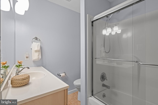 full bathroom with toilet, baseboards, combined bath / shower with glass door, and vanity