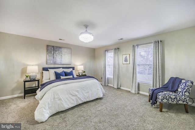 carpeted bedroom with visible vents and baseboards