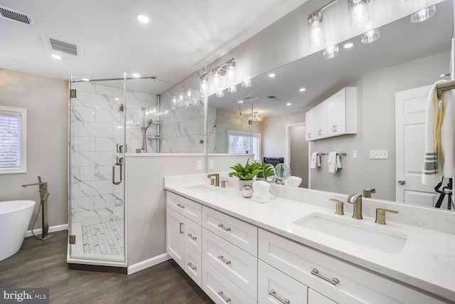 bathroom featuring a marble finish shower, visible vents, and a sink