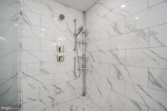 full bath with a tile shower