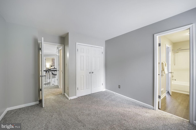 unfurnished bedroom featuring a closet, carpet, and baseboards