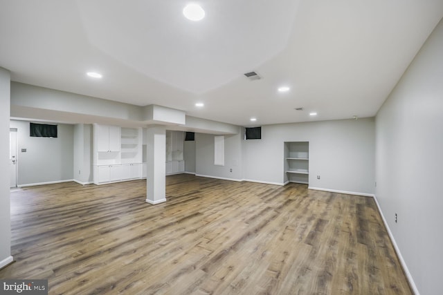 finished below grade area with baseboards, visible vents, wood finished floors, and recessed lighting