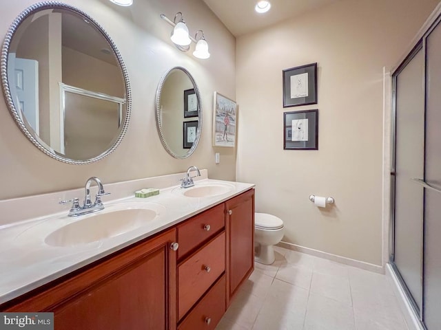 bathroom with a stall shower, tile patterned flooring, a sink, and toilet