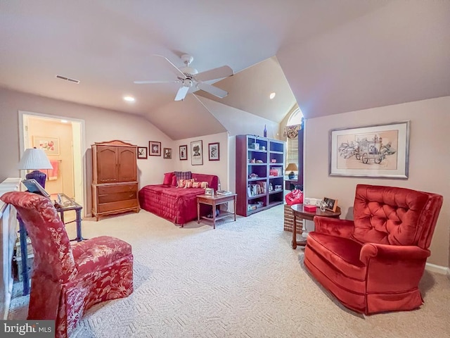 interior space with lofted ceiling, ceiling fan, carpet, and visible vents