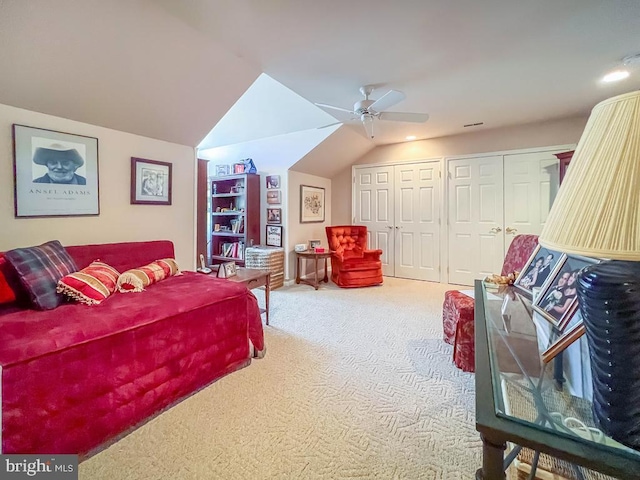 bedroom featuring vaulted ceiling, carpet floors, ceiling fan, and multiple closets