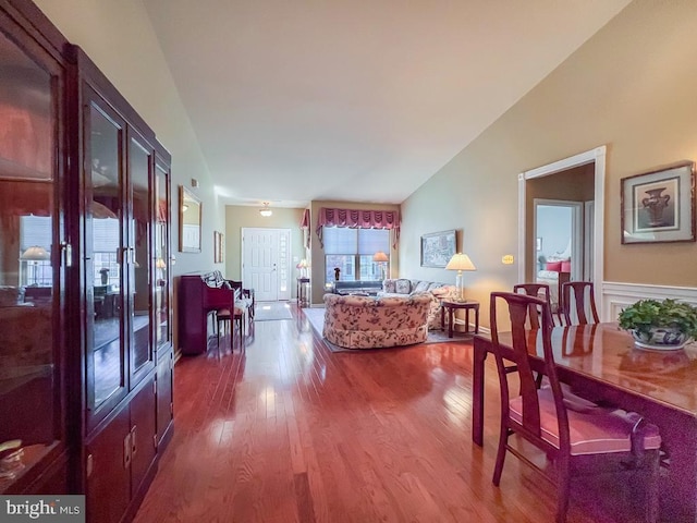 living room with vaulted ceiling, french doors, and wood finished floors