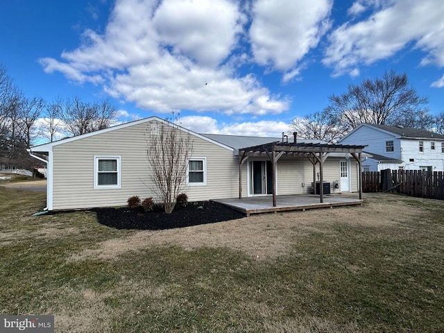 back of property with a yard, fence, a deck, and a pergola