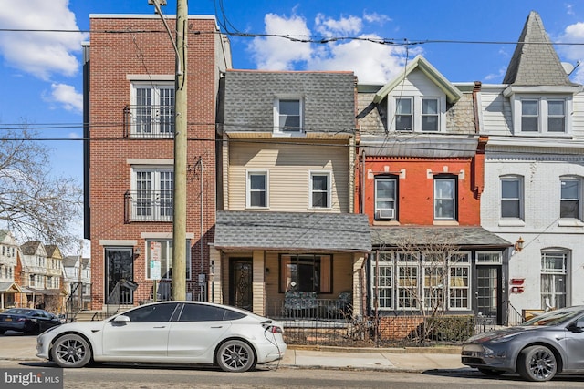 multi unit property featuring brick siding and roof with shingles