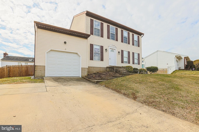 colonial-style house with a front lawn, concrete driveway, fence, and an attached garage