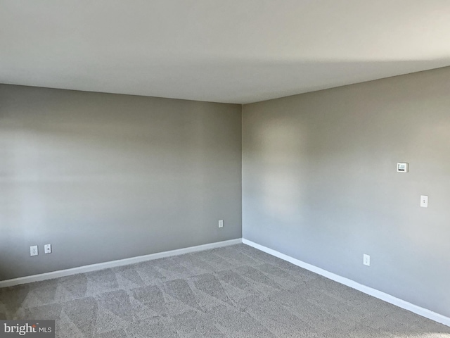 empty room with carpet floors and baseboards