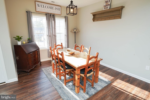 dining area featuring dark wood-style floors and baseboards