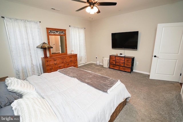 carpeted bedroom with baseboards, visible vents, and a ceiling fan