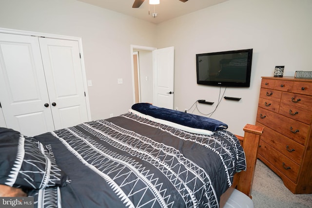 carpeted bedroom with a ceiling fan and a closet