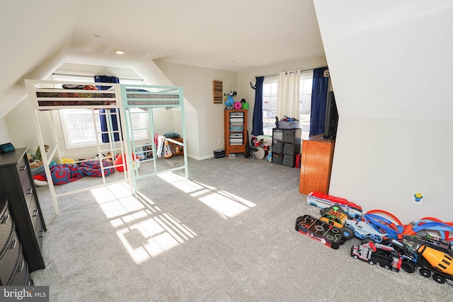 recreation room featuring carpet and lofted ceiling