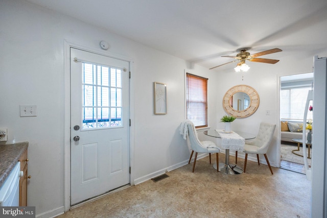 dining room with a ceiling fan, visible vents, and baseboards