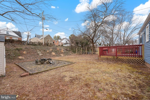 view of yard with a fire pit and a wooden deck