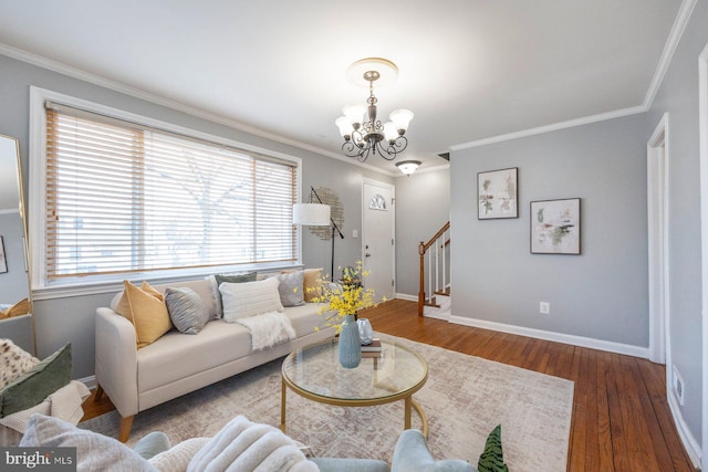 living room with crown molding, wood finished floors, a chandelier, baseboards, and stairs