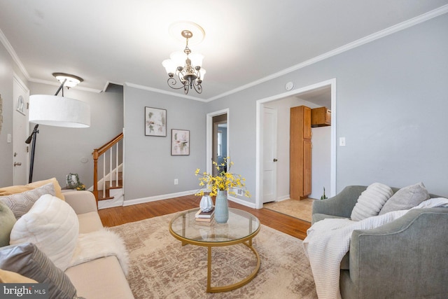 living room with a chandelier, baseboards, stairs, ornamental molding, and light wood finished floors