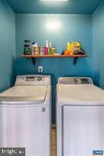 clothes washing area featuring laundry area and washer and dryer