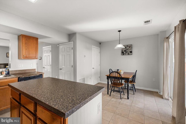 kitchen featuring dark countertops, visible vents, and brown cabinets