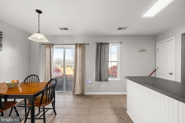 dining area featuring light tile patterned floors, visible vents, and baseboards