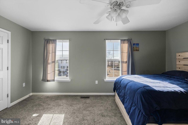 bedroom with carpet floors, visible vents, ceiling fan, and baseboards