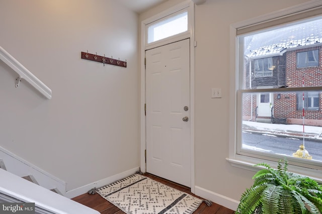 entryway featuring dark wood-type flooring and baseboards