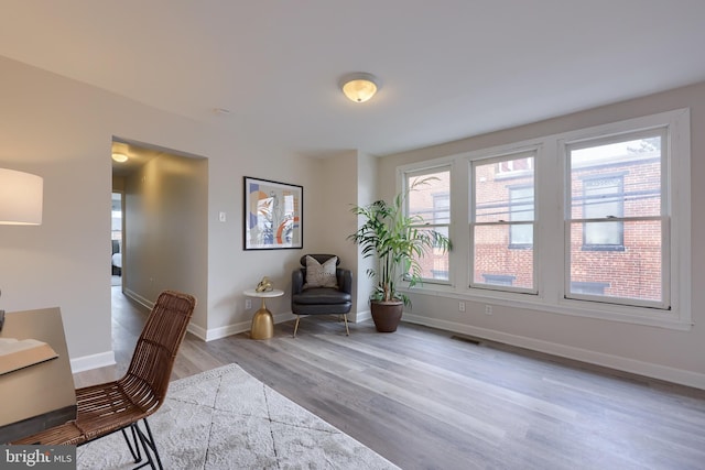 interior space with light wood finished floors, visible vents, and baseboards