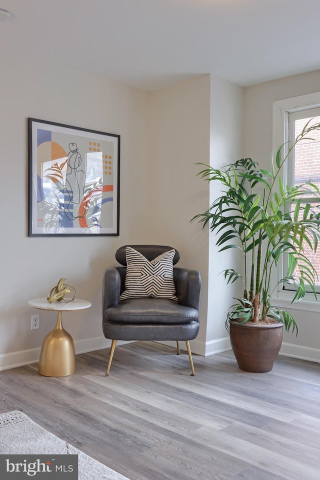 living area with light wood-style floors and baseboards