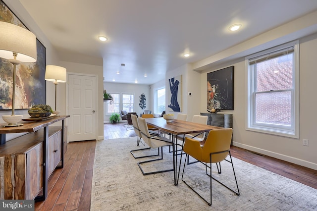 dining space with recessed lighting, visible vents, baseboards, and wood finished floors