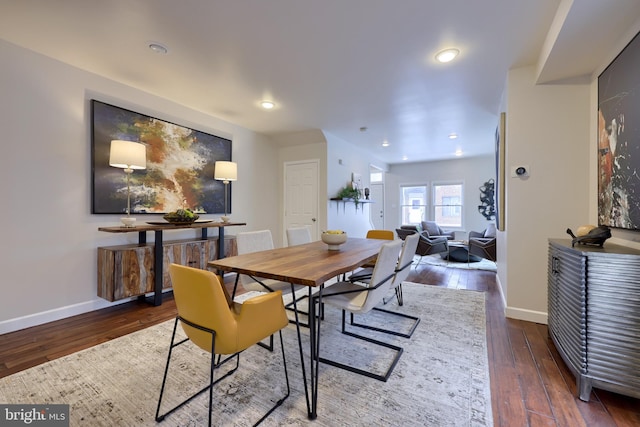 dining room with baseboards, dark wood-style flooring, and recessed lighting